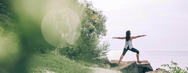 A person practicing yoga by the sea, embracing nature for stress relief, mental wellness, and relaxation. Find balance and inner peace with outdoor mindfulness.