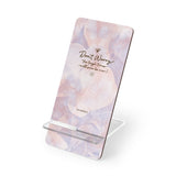 Display positivity and encouragement with the 'Don't Worry, Tough Times Fade' mobile display stand, featuring a vibrant purple and pink orchid floral design. A meaningful and practical gift for those in need of support, this stand offers a constant reminder to stay strong during tough times, while keeping your phone secure and accessible. PicaBright