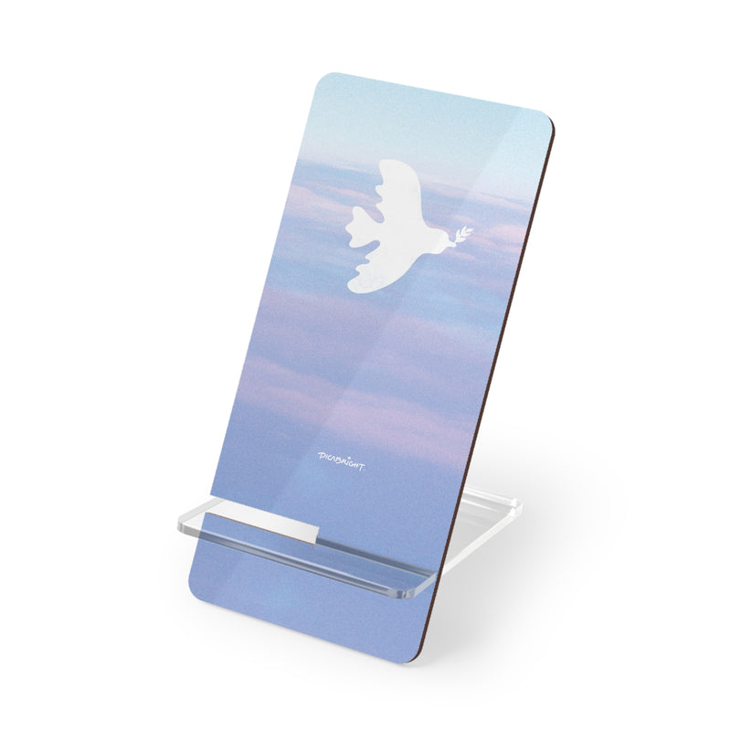 Keep your device secure with the 'Peaceful Dove' smartphone stand, featuring uplifting white dove and light blue cloud designs. A thoughtful accessory to support your daily mindfulness and emotional balance. PicaBright